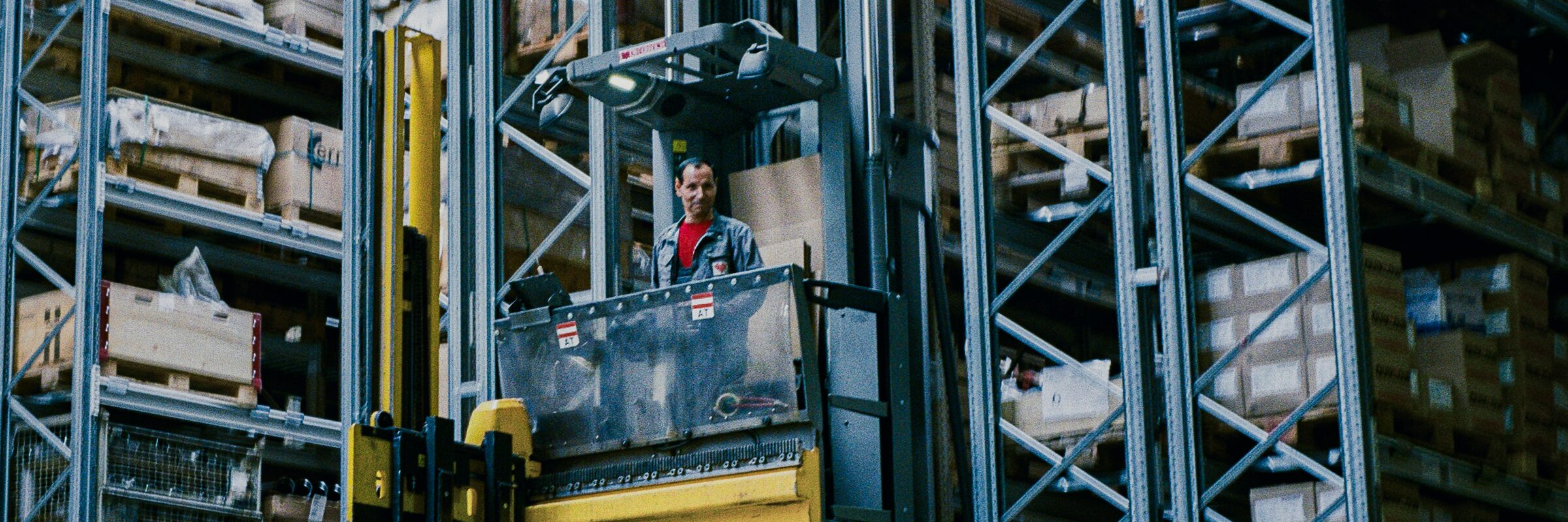 Order picking in the high-bay warehouse, from a cab between the racks.