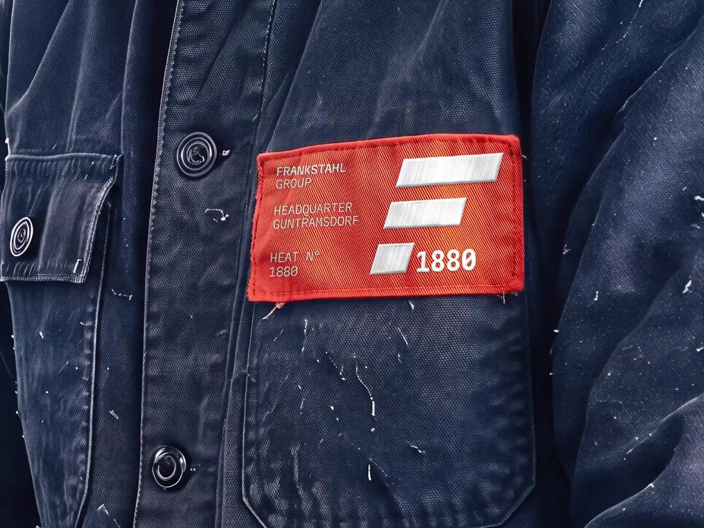 The heat patch on a worn work jacket, up close.